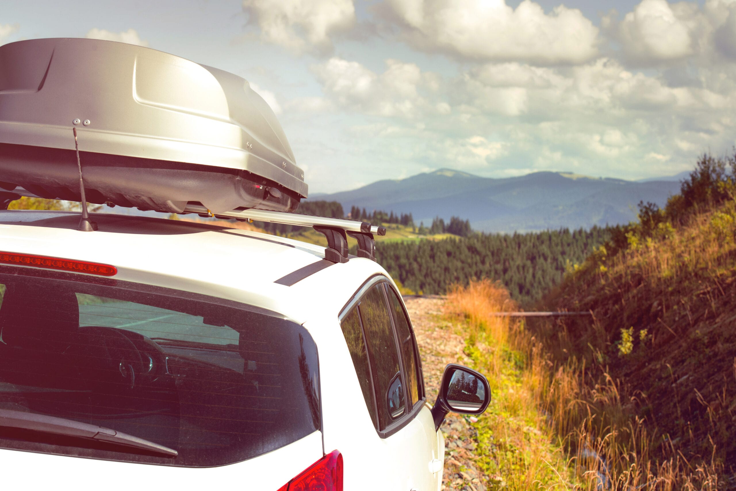 car for traveling with a roof rack on a mountain road