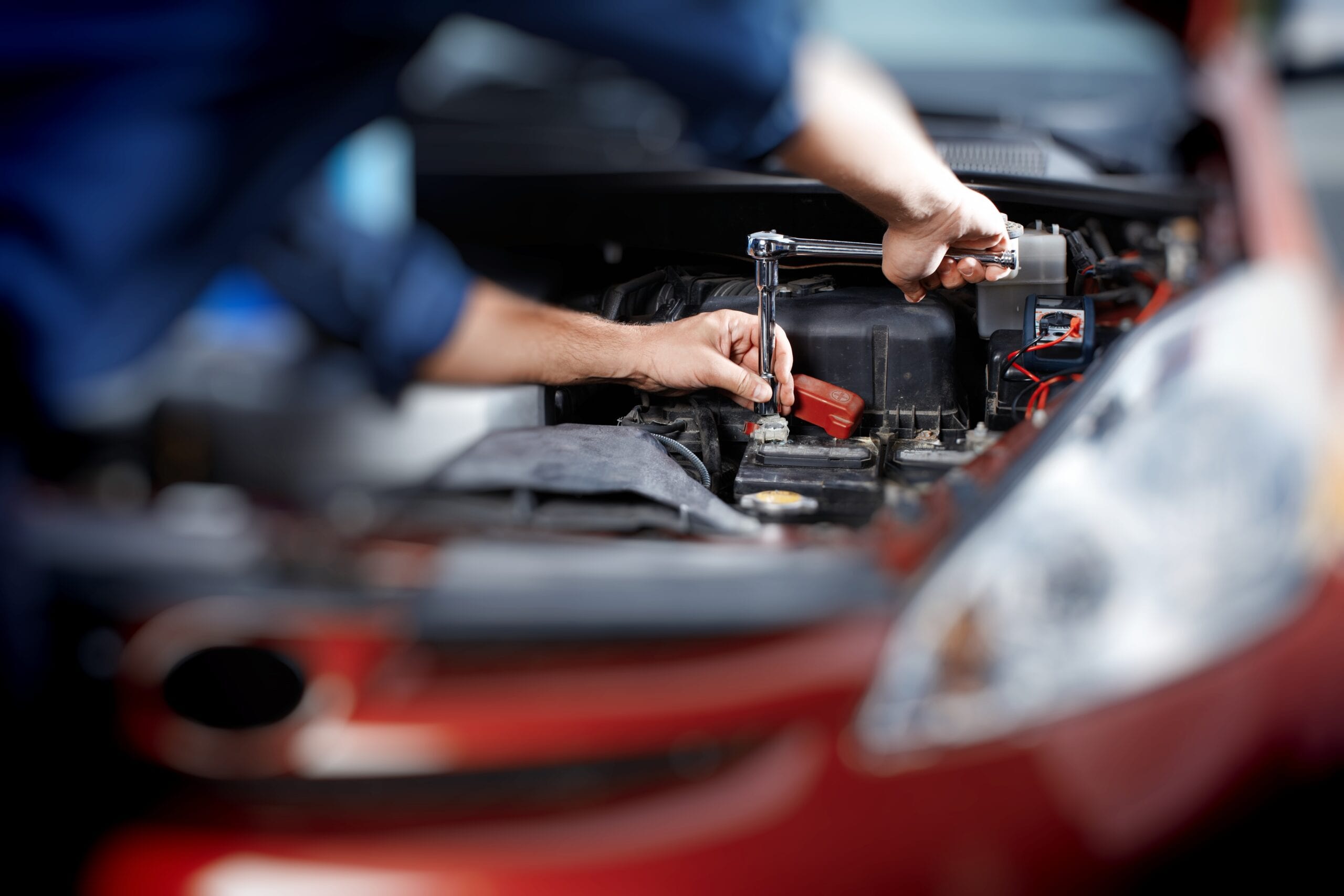 Mechanic working in auto repair garage. Car maintenance