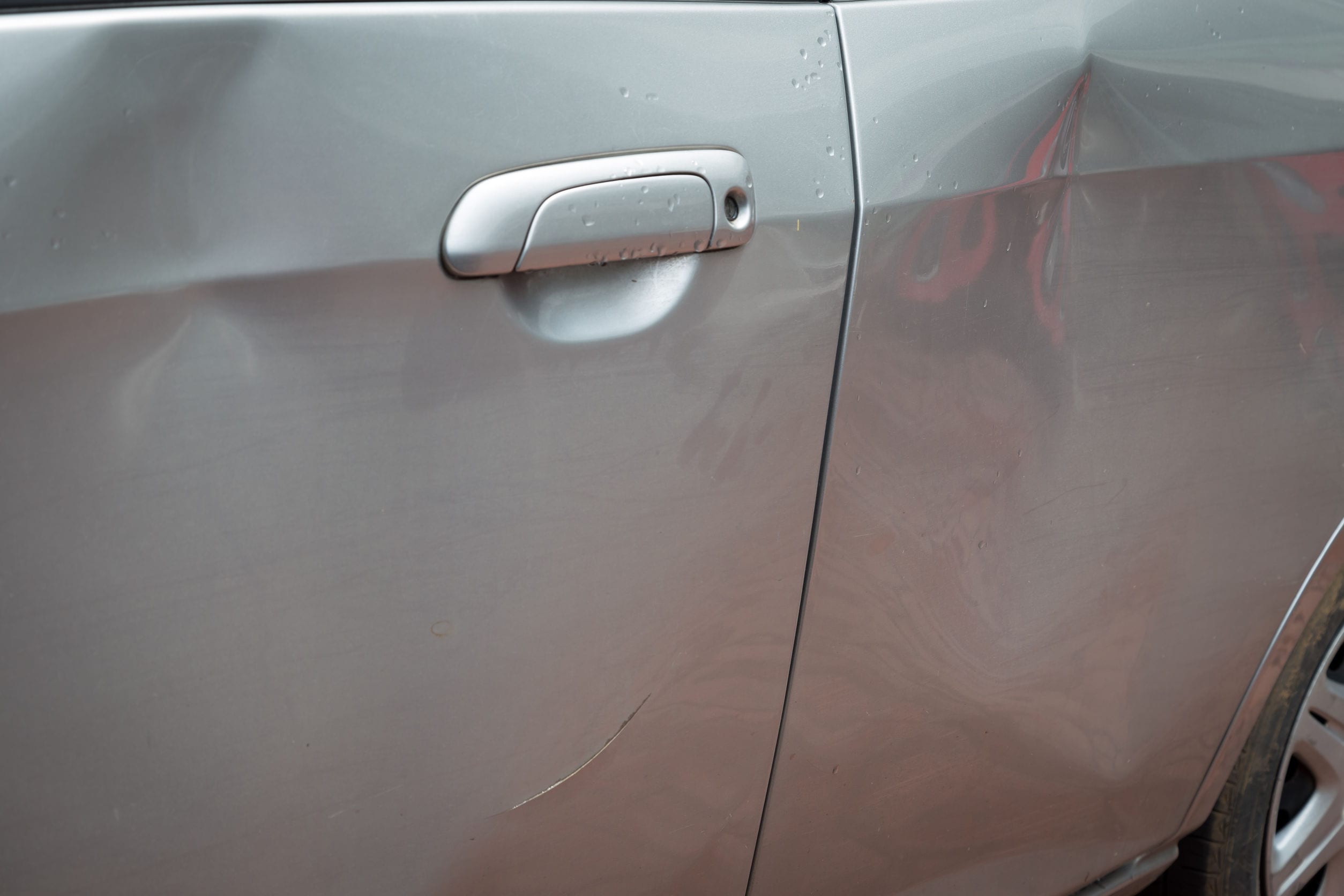 56686528 - door car with damage on accident with dent on left side on raining day